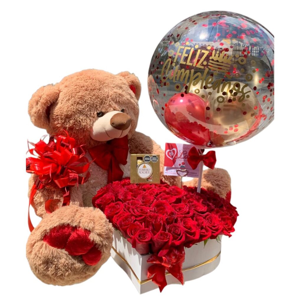 Oso café con corazón de rosas rojas, chocolates y globo burbuja.